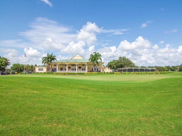 7639 15th Ln, Vero Beach, FL 32966 - surrounding community with a yard, an area to practice putting, and view of golf course