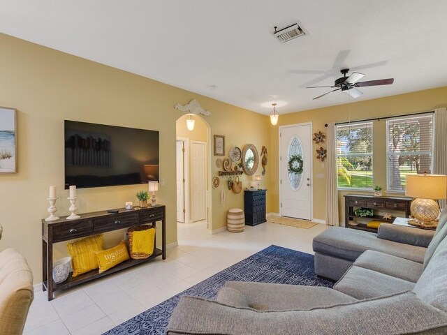 7639 15th Ln, Vero Beach, FL 32966 - living room with ceiling fan, tile patterned flooring, baseboards, and arched walkways