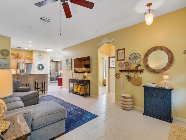 7639 15th Ln, Vero Beach, FL 32966 - living room with arched walkways, ceiling fan, light tile patterned floors, baseboards, and recessed lighting