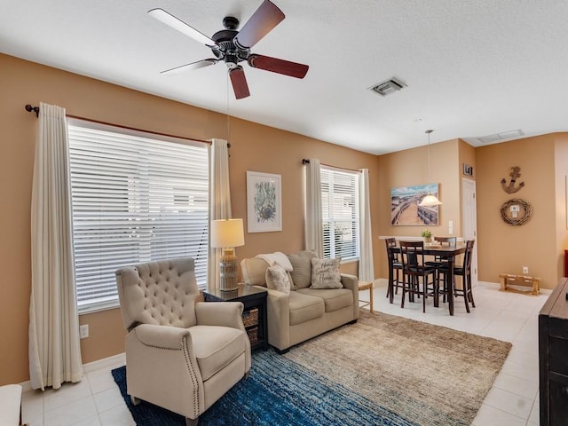 7639 15th Ln, Vero Beach, FL 32966 - living area featuring a ceiling fan, light tile patterned floors, and baseboards