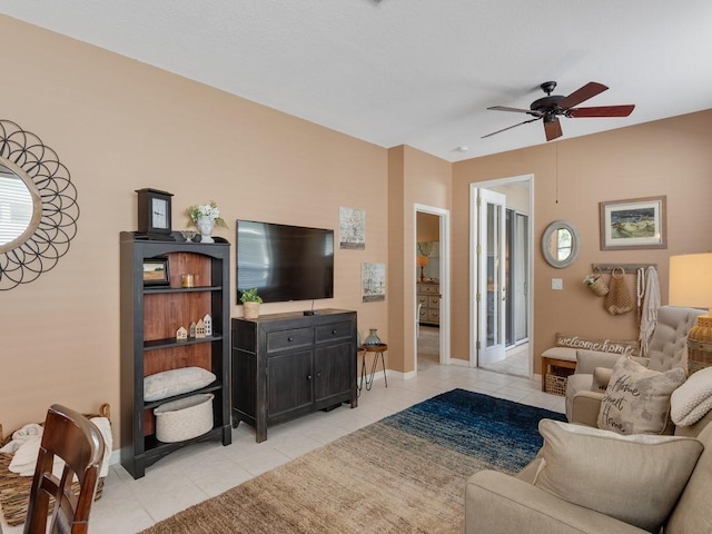 7639 15th Ln, Vero Beach, FL 32966 - living room featuring light tile patterned floors, a ceiling fan, and baseboards