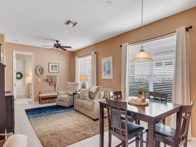 7639 15th Ln, Vero Beach, FL 32966 - dining room with healthy amount of natural light, ceiling fan, light tile patterned floors, and a textured ceiling