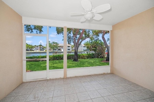 unfurnished sunroom with a water view