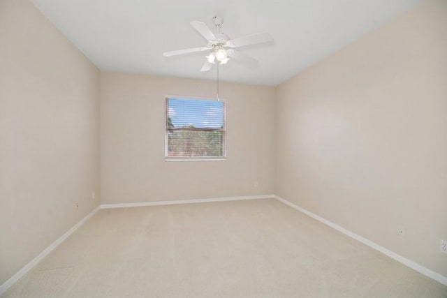 unfurnished room featuring light colored carpet and a ceiling fan