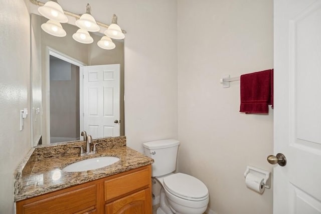 half bathroom with vanity and toilet