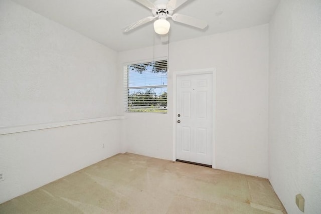 empty room featuring light carpet and ceiling fan