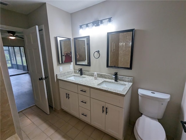 full bathroom featuring double vanity, visible vents, toilet, and a sink