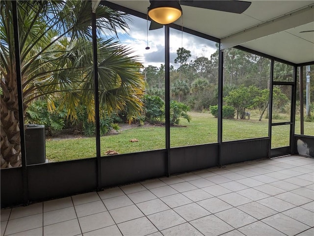 unfurnished sunroom featuring a ceiling fan