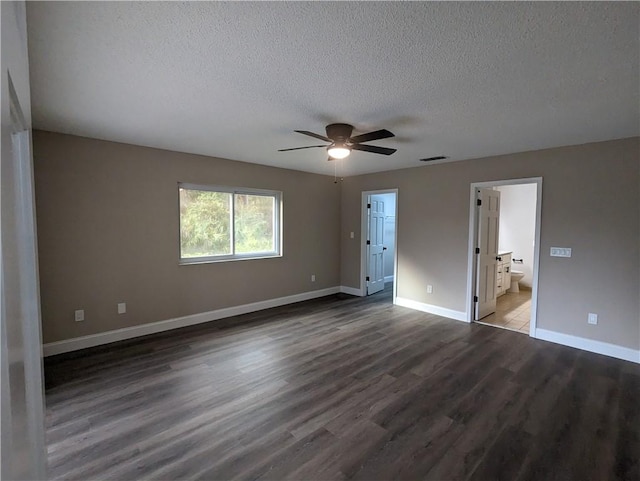 unfurnished bedroom with a textured ceiling, visible vents, baseboards, connected bathroom, and wood finished floors