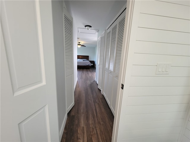 corridor with dark hardwood / wood-style flooring