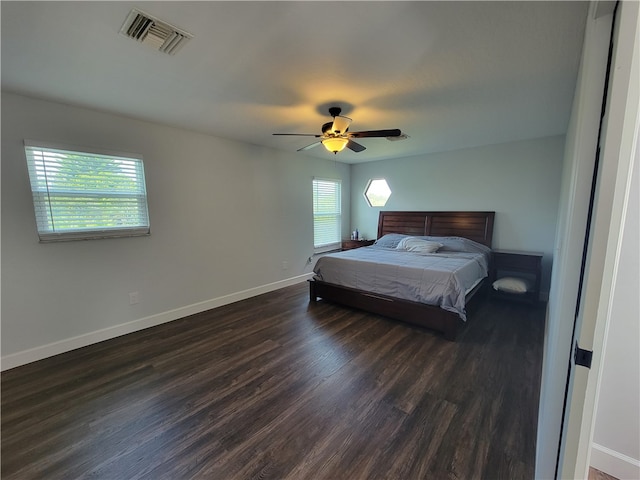 bedroom with ceiling fan and dark hardwood / wood-style floors