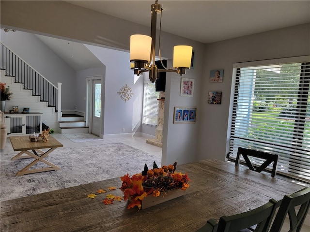 dining room with lofted ceiling and a notable chandelier