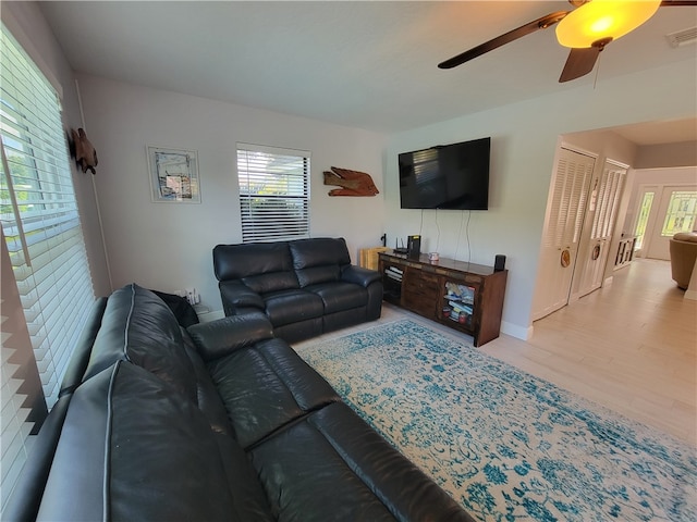 living room with ceiling fan and light wood-type flooring