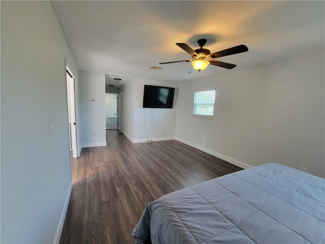 bedroom with ceiling fan and dark hardwood / wood-style floors