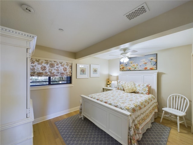 bedroom featuring beam ceiling, ceiling fan, and light hardwood / wood-style floors