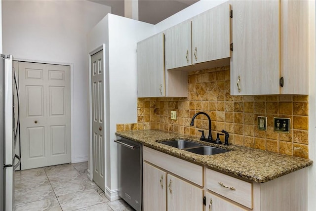 kitchen featuring tasteful backsplash, appliances with stainless steel finishes, sink, and light brown cabinets