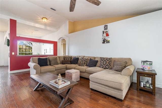 living room featuring ceiling fan, dark hardwood / wood-style floors, and vaulted ceiling