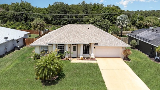 view of front of home featuring a garage, central AC unit, and a front lawn