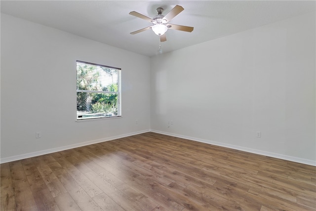 empty room featuring ceiling fan and hardwood / wood-style flooring