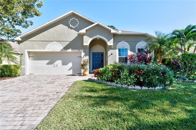 view of front of home with a garage and a front yard