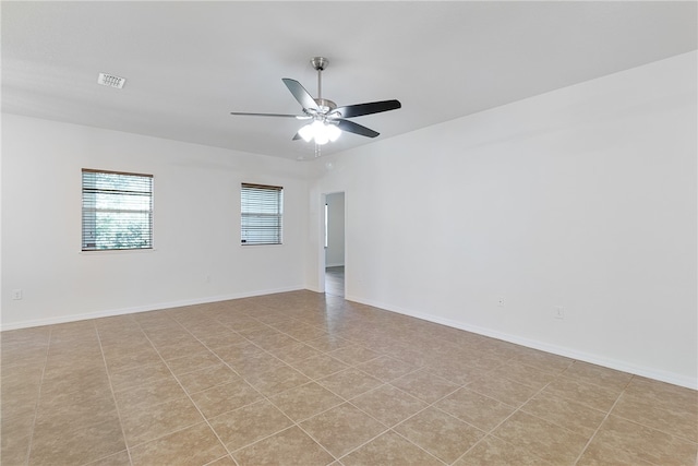 unfurnished room with light tile patterned floors and ceiling fan