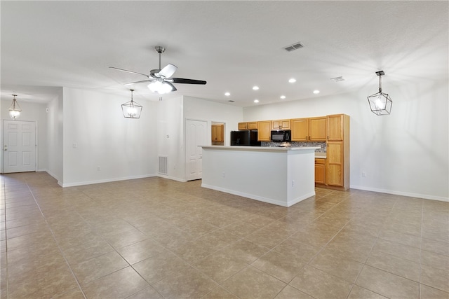 kitchen featuring light tile patterned floors, a kitchen island, ceiling fan, and black appliances