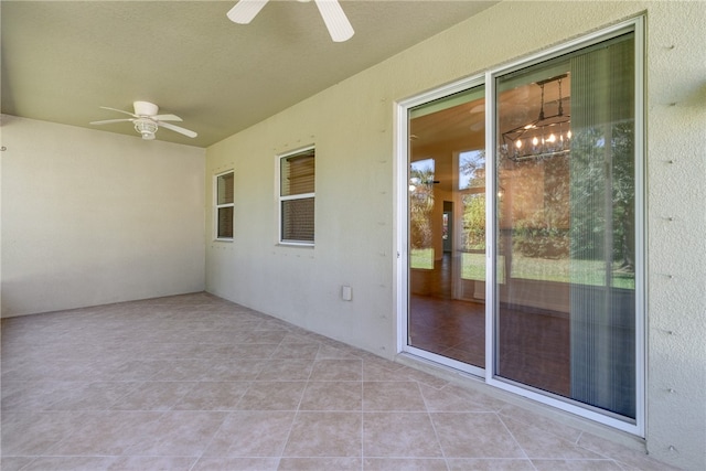 unfurnished sunroom with ceiling fan