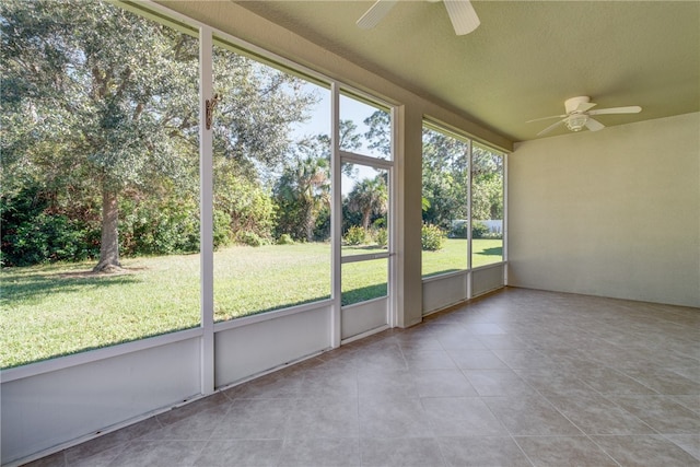 unfurnished sunroom with a wealth of natural light and ceiling fan