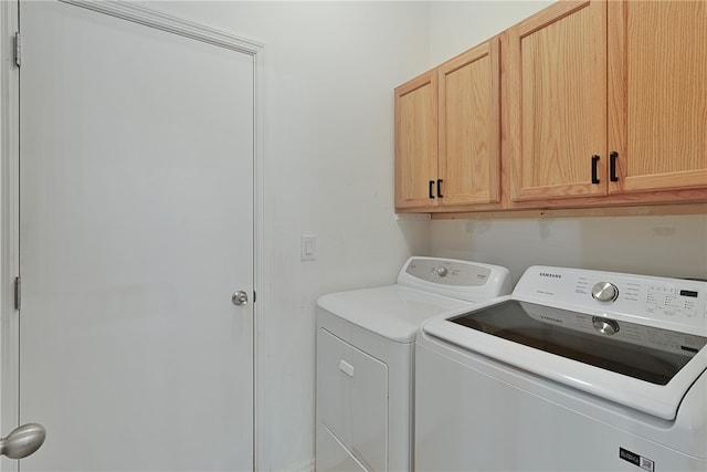 laundry room with cabinets and washing machine and dryer