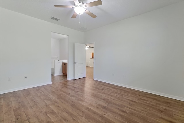 unfurnished bedroom featuring ceiling fan, light hardwood / wood-style floors, and ensuite bathroom