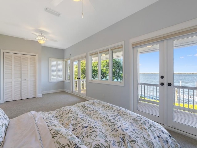 235 Osprey Ct, Vero Beach, FL 32963 - carpeted bedroom featuring access to outside, a water view, french doors, and ceiling fan