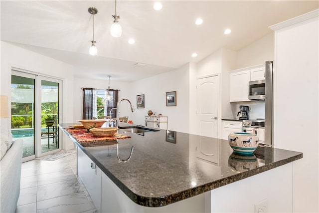 760 Holden Ave, Sebastian, FL 32958 - kitchen featuring appliances with stainless steel finishes, light marble finish flooring, white cabinets, recessed lighting, and dark stone countertops