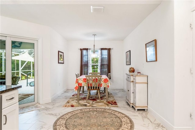 760 Holden Ave, Sebastian, FL 32958 - dining space featuring light marble finish floors and baseboards