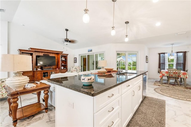 760 Holden Ave, Sebastian, FL 32958 - kitchen featuring light marble finish flooring, lofted ceiling, a ceiling fan, dark stone countertops, and a center island with sink