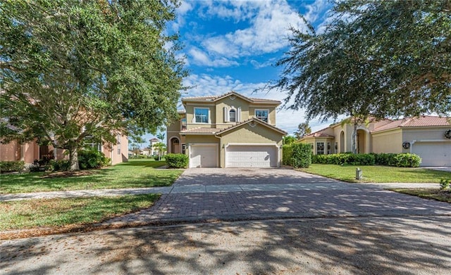 mediterranean / spanish home featuring a garage and a front yard