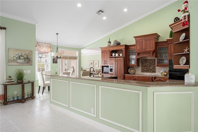 kitchen with glass insert cabinets, visible vents, hanging light fixtures, and a peninsula