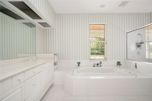 bathroom featuring wallpapered walls, tile patterned floors, a garden tub, a tile shower, and vanity