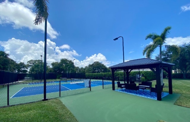 view of tennis court with a gazebo and fence