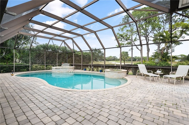 view of swimming pool featuring a lanai, a patio area, and a pool with connected hot tub