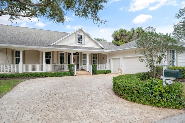 view of front of home featuring a porch and a garage