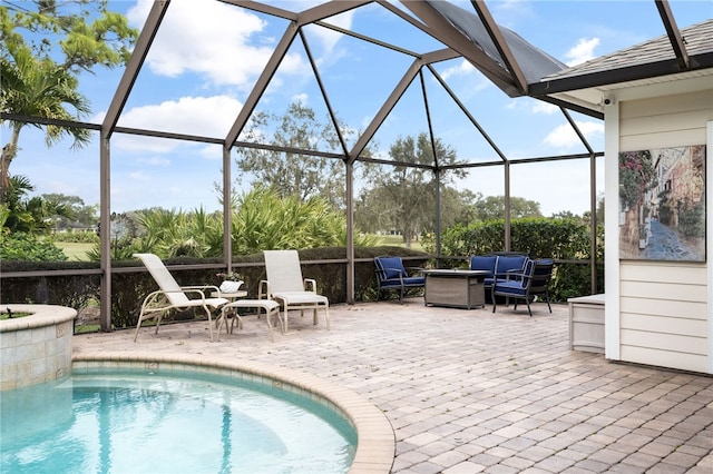 outdoor pool with glass enclosure, a patio, and outdoor lounge area