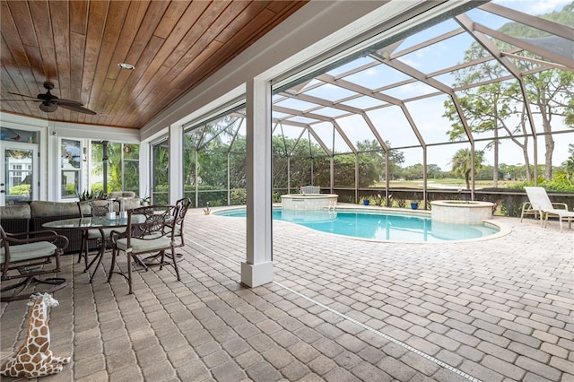 view of pool featuring ceiling fan, a patio area, a lanai, and a pool with connected hot tub