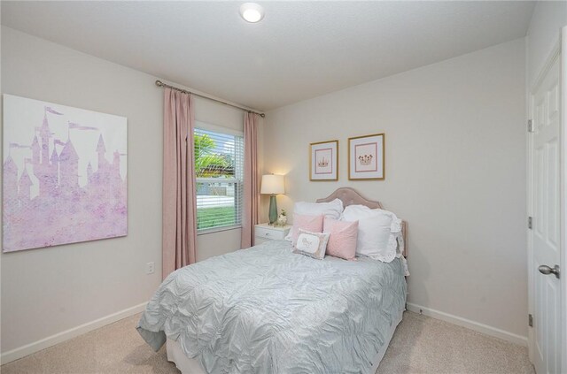 bedroom featuring baseboards and carpet flooring