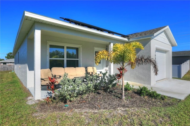 view of home's exterior featuring a garage and covered porch