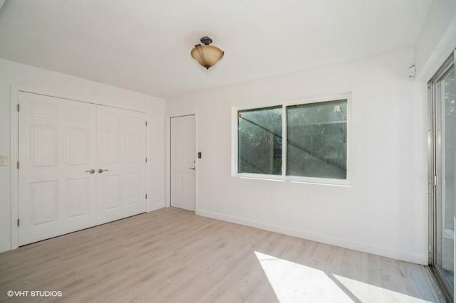 7645 58th Ave, Vero Beach, FL 32967 - interior space featuring baseboards, wood finished floors, multiple windows, and a closet