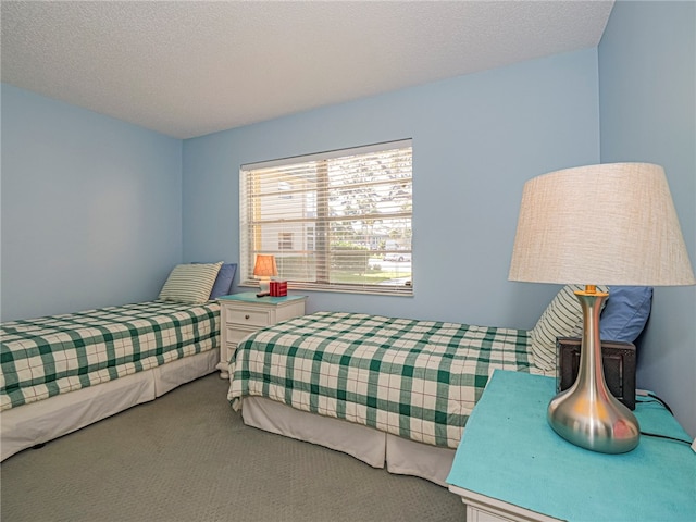 carpeted bedroom featuring a textured ceiling