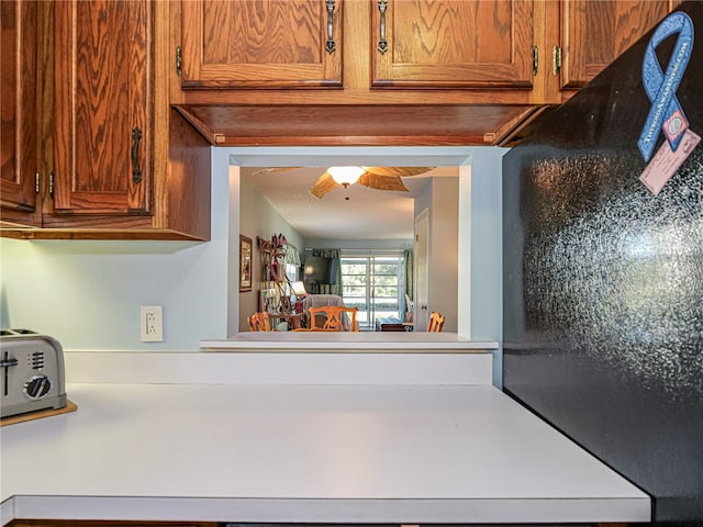 kitchen featuring a toaster and brown cabinetry