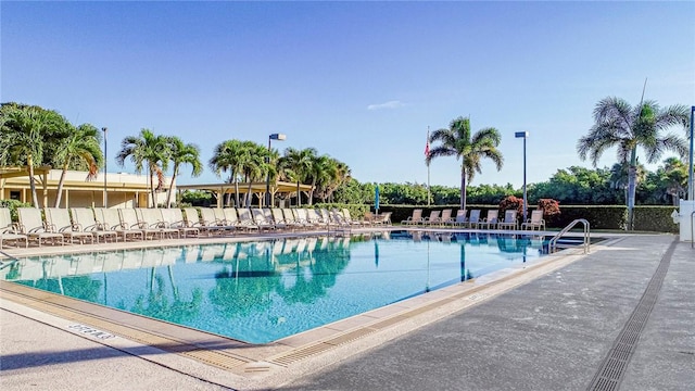 pool featuring fence and a patio