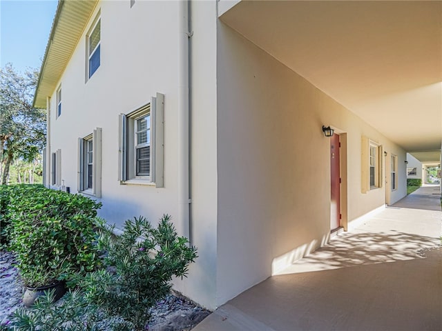 view of side of property with stucco siding