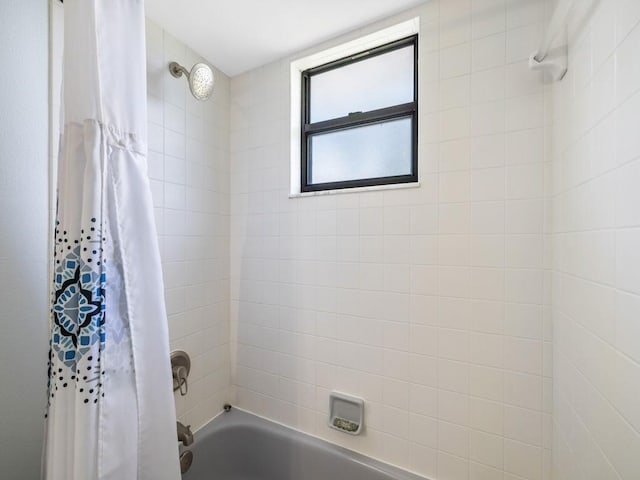 bathroom with shower / tub combo with curtain